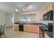 Spacious kitchen with an open layout and stainless steel appliances at 44977 W Miraflores St, Maricopa, AZ 85139