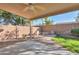 Covered patio, fire pit, and grassy area at 44977 W Miraflores St, Maricopa, AZ 85139