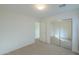 Bright bedroom with mirrored closet doors and neutral carpeting at 44977 W Miraflores St, Maricopa, AZ 85139