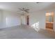 Spacious bedroom with ceiling fan and en-suite bathroom access at 44977 W Miraflores St, Maricopa, AZ 85139