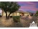 Landscaped backyard with a patio and mature trees at 14220 W Wagon Wheel Dr, Sun City West, AZ 85375