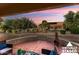 Covered patio with fire pit and seating area overlooking backyard at 14220 W Wagon Wheel Dr, Sun City West, AZ 85375