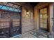 Inviting entryway with decorative iron doors and a charming stone exterior at 37440 N 104Th Pl, Scottsdale, AZ 85262