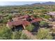 Aerial view of a large estate home showcasing its Spanish-style architecture and landscaping at 37440 N 104Th Pl, Scottsdale, AZ 85262