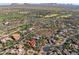 Aerial view of upscale homes nestled in a golf course community with desert mountain views at 37440 N 104Th Pl, Scottsdale, AZ 85262