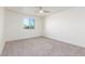 Well-lit bedroom with carpet, window, and ceiling fan at 3609 E Ludlow Dr, Phoenix, AZ 85032