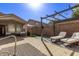 Relaxing backyard patio with pergola, comfortable seating, and artificial turf at 8010 W Adam Ave, Peoria, AZ 85382