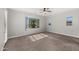 Bright bedroom with carpet flooring, ceiling fan, and large window at 7205 W Fallen Leaf Ln, Peoria, AZ 85383