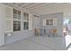 Covered patio with small table and chairs, offering shade and comfort at 2550 S Ellsworth Rd # 215, Mesa, AZ 85209