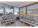 Peaceful sunroom with wicker furniture offering views of the community at 2550 S Ellsworth Rd # 215, Mesa, AZ 85209