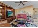 Living room boasts a large entertainment center and comfortable seating at 2550 S Ellsworth Rd # 215, Mesa, AZ 85209