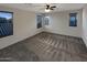 Spacious bedroom with two windows and ceiling fan at 16259 W La Ventilla Way, Goodyear, AZ 85338