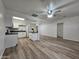 Open concept kitchen and dining area with white cabinets and wood-look floors at 4622 S 21St St, Phoenix, AZ 85040