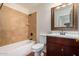 Clean bathroom with tile shower and wood vanity at 8143 E Obispo Ave, Mesa, AZ 85212