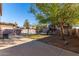 Landscaped backyard with pool and playset at 8143 E Obispo Ave, Mesa, AZ 85212