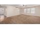 Living room with carpet, neutral walls, and access to laundry and stairs at 8143 E Obispo Ave, Mesa, AZ 85212