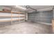 Garage with built-in shelving and overhead storage at 8143 E Obispo Ave, Mesa, AZ 85212