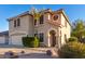 Two-story house with a tan stucco exterior and a two-car garage at 8143 E Obispo Ave, Mesa, AZ 85212
