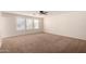 Large bedroom with three windows and a ceiling fan at 8143 E Obispo Ave, Mesa, AZ 85212