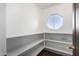 Bright pantry with ample shelving and an octagonal window at 8143 E Obispo Ave, Mesa, AZ 85212