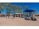 Community playground with swings, slides, and shade structure at 8143 E Obispo Ave, Mesa, AZ 85212