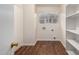Laundry room with wood-look floors and built-in shelving at 8143 E Obispo Ave, Mesa, AZ 85212