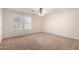 Bright bedroom with two windows and ceiling fan at 8143 E Obispo Ave, Mesa, AZ 85212