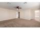 Spacious bedroom with ceiling fan and access to bathroom at 8143 E Obispo Ave, Mesa, AZ 85212