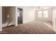 Bright bedroom with carpet, ceiling fan and access to a hallway at 8143 E Obispo Ave, Mesa, AZ 85212