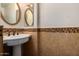 Bathroom with pedestal sink and tile flooring at 8143 E Obispo Ave, Mesa, AZ 85212