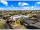 Aerial view of a house with solar panels, landscaped yard, and mountain views at 6520 N 130Th Ln, Glendale, AZ 85307