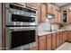 Stainless steel double oven and cooktop with granite countertops at 6520 N 130Th Ln, Glendale, AZ 85307