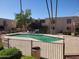 Community pool with surrounding patio furniture and landscaping at 3314 N 68Th St # 204, Scottsdale, AZ 85251