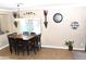 Bright dining room with a square table and six chairs, window, and wall decor at 901 W Witt Ave, Queen Creek, AZ 85140