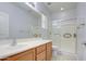 Bathroom boasts wood cabinets and a shower at 40998 W Chambers Dr, Maricopa, AZ 85138