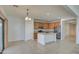 Kitchen with island, stainless steel appliances, and light wood cabinets at 40998 W Chambers Dr, Maricopa, AZ 85138