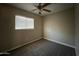 Bright bedroom with window, ceiling fan and carpet flooring at 3542 E Earll Dr, Phoenix, AZ 85018