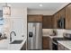 Modern kitchen with stainless steel appliances and an island with seating at 9243 E Sector Dr, Mesa, AZ 85212