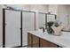 Modern bathroom with a walk-in shower and double vanity at 9243 E Sector Dr, Mesa, AZ 85212