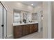 Double vanity bathroom with a large mirror and a walk-in shower at 9243 E Sector Dr, Mesa, AZ 85212