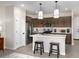 Modern kitchen with an island, stainless steel appliances, and dark brown cabinets at 9243 E Sector Dr, Mesa, AZ 85212