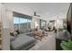 Open-concept living room with L-shaped sofa and dining area at 9243 E Sector Dr, Mesa, AZ 85212