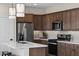 Modern kitchen with stainless steel appliances and an island with seating at 9243 E Sector Dr, Mesa, AZ 85212