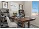 Home office features a large wooden desk, shelving and natural light at 9243 E Sector Dr, Mesa, AZ 85212