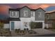 Two story home with gray siding and teal door at 9237 E Sector Dr, Mesa, AZ 85212