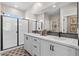 Modern bathroom with double vanity, large mirror, and walk-in shower at 9237 E Sector Dr, Mesa, AZ 85212