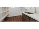 Laundry area with sink, shelving, and dark cabinetry at 3823 W Lodge Dr, Laveen, AZ 85339