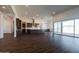 Open floor plan with kitchen island, dark floors and sliding door access to patio at 3823 W Lodge Dr, Laveen, AZ 85339