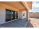 Covered patio with sliding glass doors leading to the backyard at 3823 W Lodge Dr, Laveen, AZ 85339