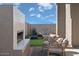 Cozy outdoor fireplace with seating and grassy backyard at 9233 E Sector Dr, Mesa, AZ 85212